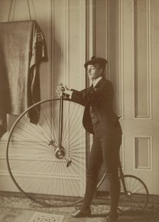 Frances Benjamin Johnston, full-length self-portrait dressed as a man with false..., c1890 - 1900. Creator: Frances Benjamin Johnston