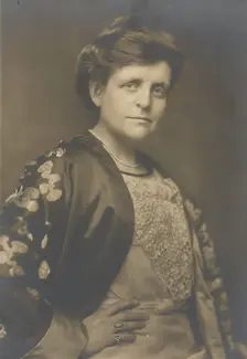 Frances Benjamin Johnston, half-length portrait, turned to the right, facing front, with..., 1911. Creator: William H Towles