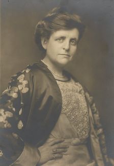 Frances Benjamin Johnston, half-length portrait, turned to the right, facing front, with..., 1911. Creator: William H Towles