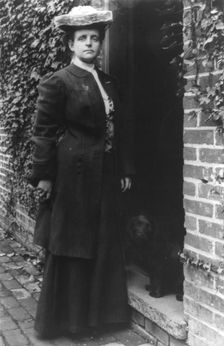 Frances Benjamin Johnston, in doorway with cocker spaniel, n.d.. Creator: Frances Benjamin Johnston