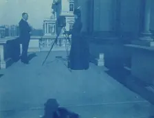 Frances Benjamin Johnston on a balcony of the State, War and Navy Building with a tripod..., 1888. Creator: Frances Benjamin Johnston