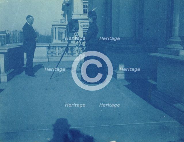 Frances Benjamin Johnston on a balcony of the State, War and Navy Building with a tripod..., 1888. Creator: Frances Benjamin Johnston.
