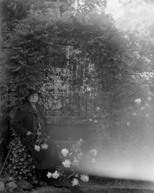 Frances Benjamin Johnston, photographer, posed sitting with peonies..., Takoma Park, Maryland, 1938. Creator: Unknown