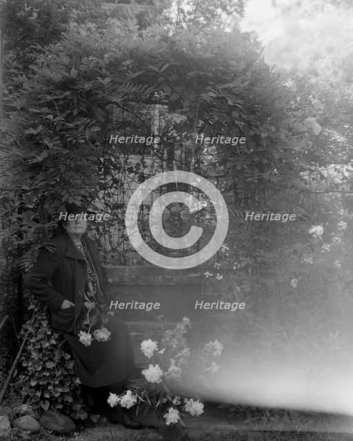 Frances Benjamin Johnston, photographer, posed sitting with peonies..., Takoma Park, Maryland, 1938. Creator: Unknown.