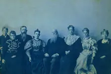 Frances Benjamin Johnston posed with seven members of her family, in her Washington..., 1896. Creator: Frances Benjamin Johnston