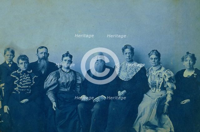 Frances Benjamin Johnston posed with seven members of her family, in her Washington..., 1896. Creator: Frances Benjamin Johnston.