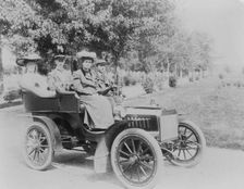 Frances Benjamin Johnston seated with three other people in automobile, between 1890 and 1910. Creator: Unknown