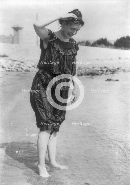 Frances Benjamin Johnston, standing in surf in wet bathing suit, n.d.. Creator: Frances Benjamin Johnston.