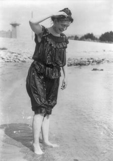 Frances Benjamin Johnston, standing in surf in wet bathing suit, n.d.. Creator: Frances Benjamin Johnston