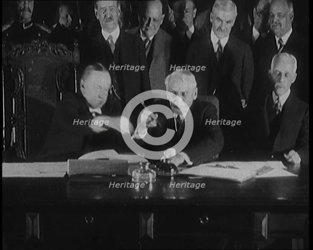 Frank Billings Kellogg Sitting Next to American President Calvin Coolidge Signing the Kellogg...1929 Creator: British Pathe Ltd.