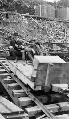 Frank G. Carpenter and man sitting on tracks, between c1900 and 1924. Creator: Unknown