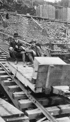 Frank G. Carpenter and man sitting on tracks, between c1900 and 1924. Creator: Unknown