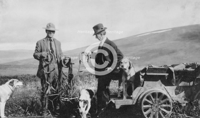 Frank G. Carpenter beside pupmobile, between c1900 and 1916. Creator: Unknown.