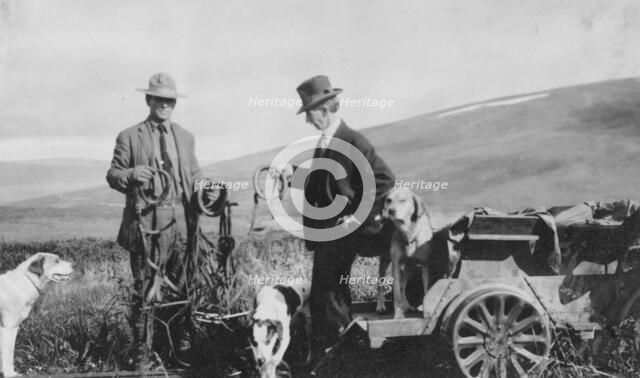 Frank G. Carpenter beside pupmobile, between c1900 and 1916. Creator: Unknown.