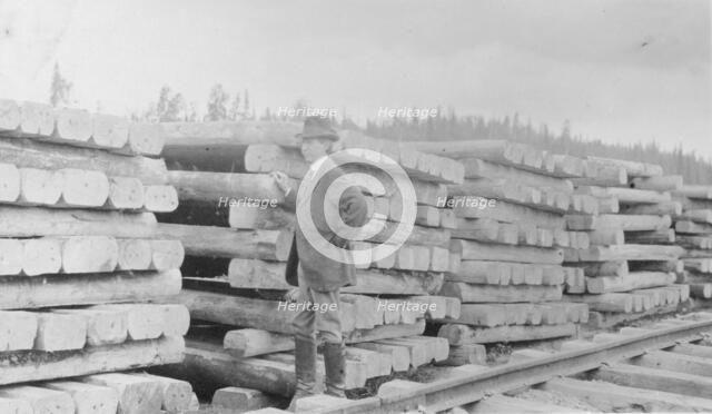 Frank G. Carpenter standing by railroad ties, between c1900 and 1916. Creator: Unknown.
