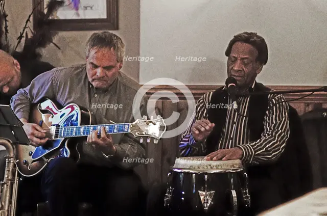Frank Holder, Guyanan jazz singer and percussionist with Shane Hill, The Castle, Outwood, Surrey.    Artist: Brian O'Connor