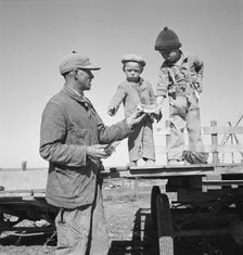 Franklin Schroeder and his older boys in the yard, Dead Ox Flat, Malheur County, Oregon, 1939. Creator: Dorothea Lange