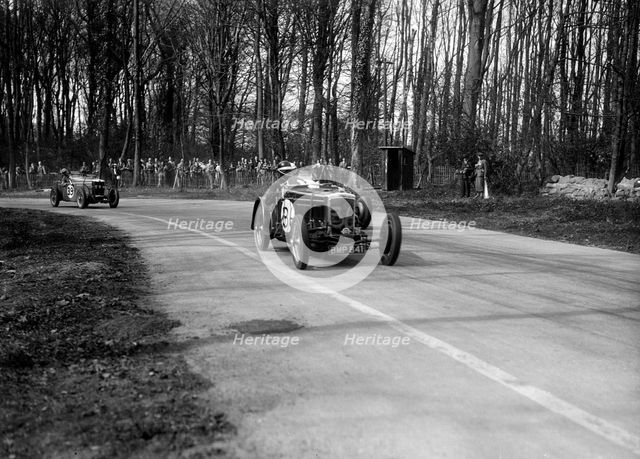 Frazer-Nash Byfleet II leading an MG at Donington Park, Leicestershire, 1935. Artist: Bill Brunell.