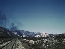 Freight train going up Cajon Pass through the San Bernardino Mountains, Cajon, Calif., 1943. Creator: Jack Delano