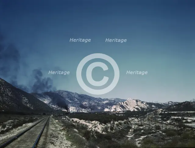 Freight train going up Cajon Pass through the San Bernardino Mountains, Cajon, Calif., 1943. Creator: Jack Delano.