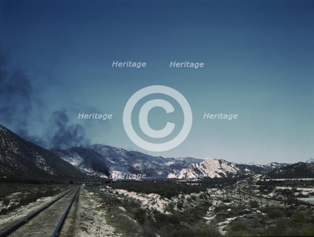 Freight train going up Cajon Pass through the San Bernardino Mountains, Cajon, Calif., 1943. Creator: Jack Delano.