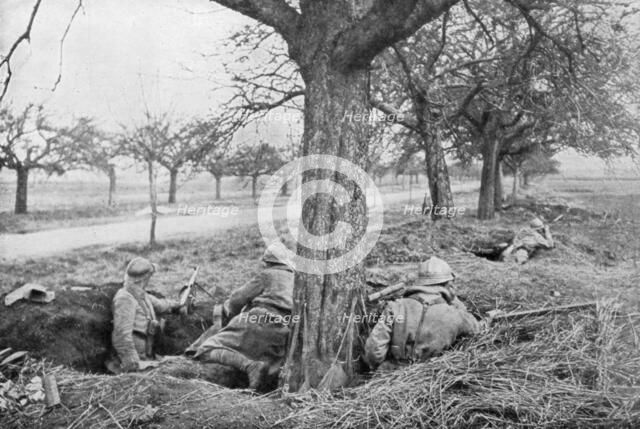 French machine gunners dug in at the edge of a road, under apple trees, 1918. Artist: Unknown