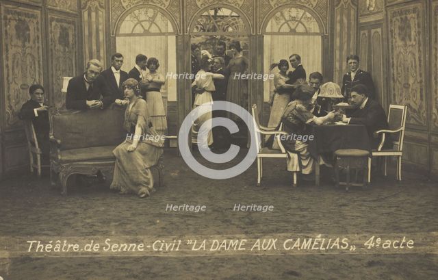 French or Belgian prisoners of war, some in drag, posing on stage during a crowded scene..., (1918?) Creator: Unknown.