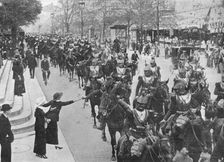 French cuirassiers riding through the streets of Paris on their way on the front 1914