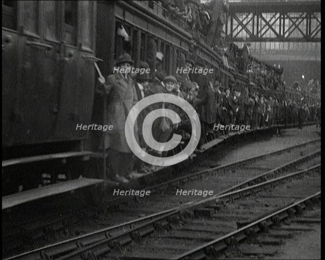 French People Hanging Onto the Outside of a Packed Train as It Drives Along, 1920. Creator: British Pathe Ltd.