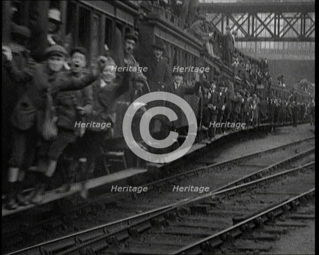 French People Hanging Onto the Outside of a Packed Train as It Drives Along, 1920. Creator: British Pathe Ltd.