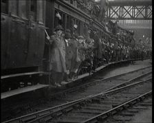 French People Hanging Onto the Outside of a Packed Train as It Drives Along, 1920. Creator: British Pathe Ltd