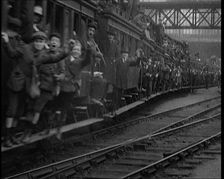 French People Hanging Onto the Outside of a Packed Train as It Drives Along, 1920. Creator: British Pathe Ltd