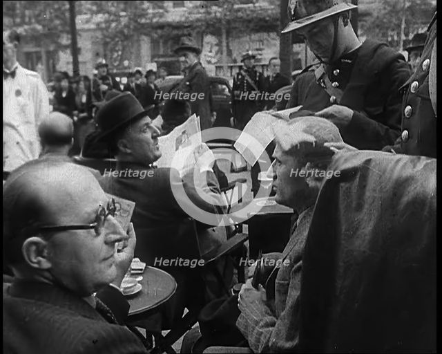 French Police Checking People's Papers Outside a Cafe in Paris, 1940. Creator: British Pathe Ltd.