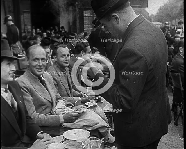 French Police Checking People's Papers Outside a Cafe in Paris, 1940. Creator: British Pathe Ltd.