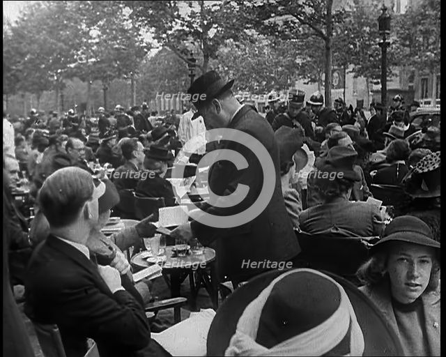 French Police Checking People's Papers Outside a Cafe in Paris, 1940. Creator: British Pathe Ltd.