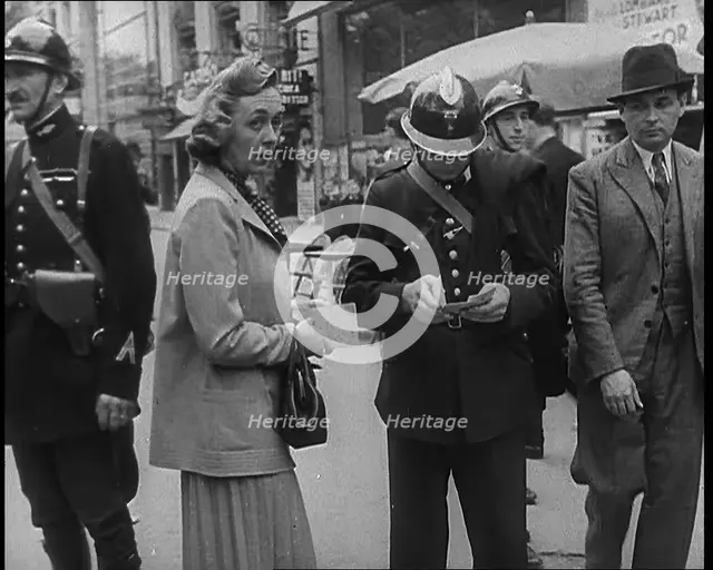 French Police Checking People's Papers Outside a Cafe in Paris, 1940. Creator: British Pathe Ltd.