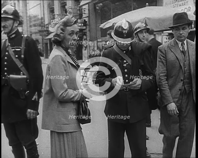 French Police Checking People's Papers Outside a Cafe in Paris, 1940. Creator: British Pathe Ltd.