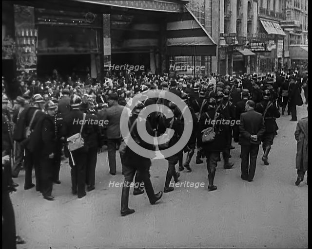 French Police Checking People's Papers Outside a Cafe in Paris, 1940. Creator: British Pathe Ltd.