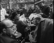 French Police Checking People's Papers Outside a Cafe in Paris, 1940. Creator: British Pathe Ltd