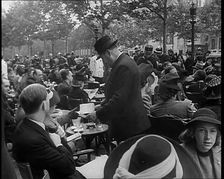 French Police Checking People's Papers Outside a Cafe in Paris, 1940. Creator: British Pathe Ltd
