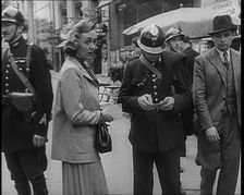 French Police Checking People's Papers Outside a Cafe in Paris, 1940. Creator: British Pathe Ltd