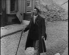 French Refugee Walking Through Demolished Town, 1940. Creator: British Pathe Ltd