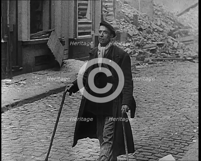 French Refugee Walking Through Demolished Town, 1940. Creator: British Pathe Ltd.