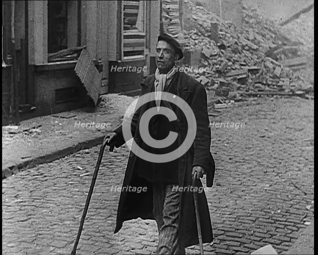 French Refugee Walking Through Demolished Town, 1940. Creator: British Pathe Ltd.