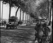 French Refugees Fleeing Town Down Country Roads, British Forces Moving Past Them, 1940. Creator: British Pathe Ltd