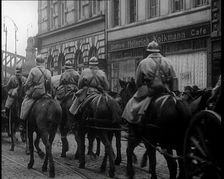 French Soldiers on Horseback Ride Past the Heinrich Kolkmann Cafe 1924. Creator: British Pathe Ltd