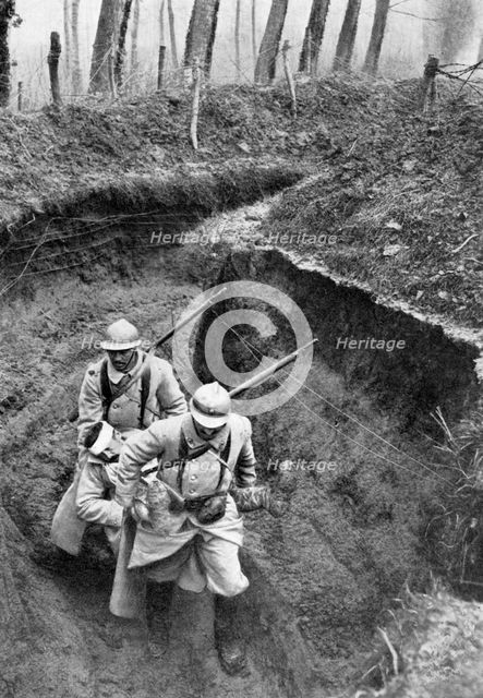 French soldiers carrying a wounded companion from the front, First World War, 1917, (c1920). Artist: Unknown