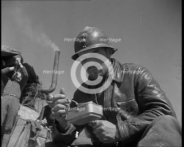 French Soldiers Eating a Meal in a Dug Out, 1940. Creator: British Pathe Ltd.