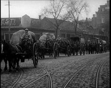 French Soldiers Escort Wagons Down a Cobbled Street, 1924. Creator: British Pathe Ltd