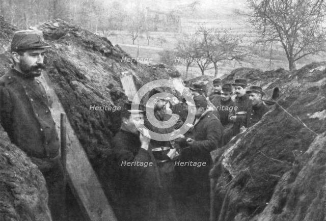 French soldiers in the trenches eating their rations, France, 1915. Artist: Unknown